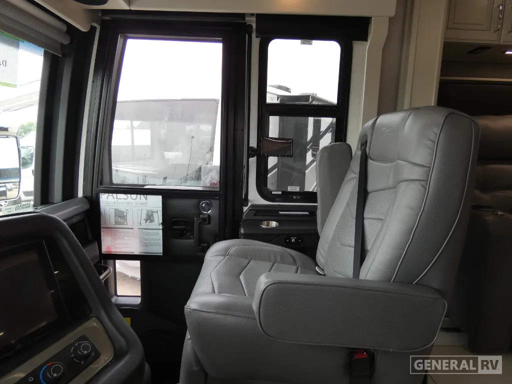 2026 American Coach American Dream 45A — Class A cockpit passenger seat beside the entry door, side windows, dashboard edge, and interior controls
