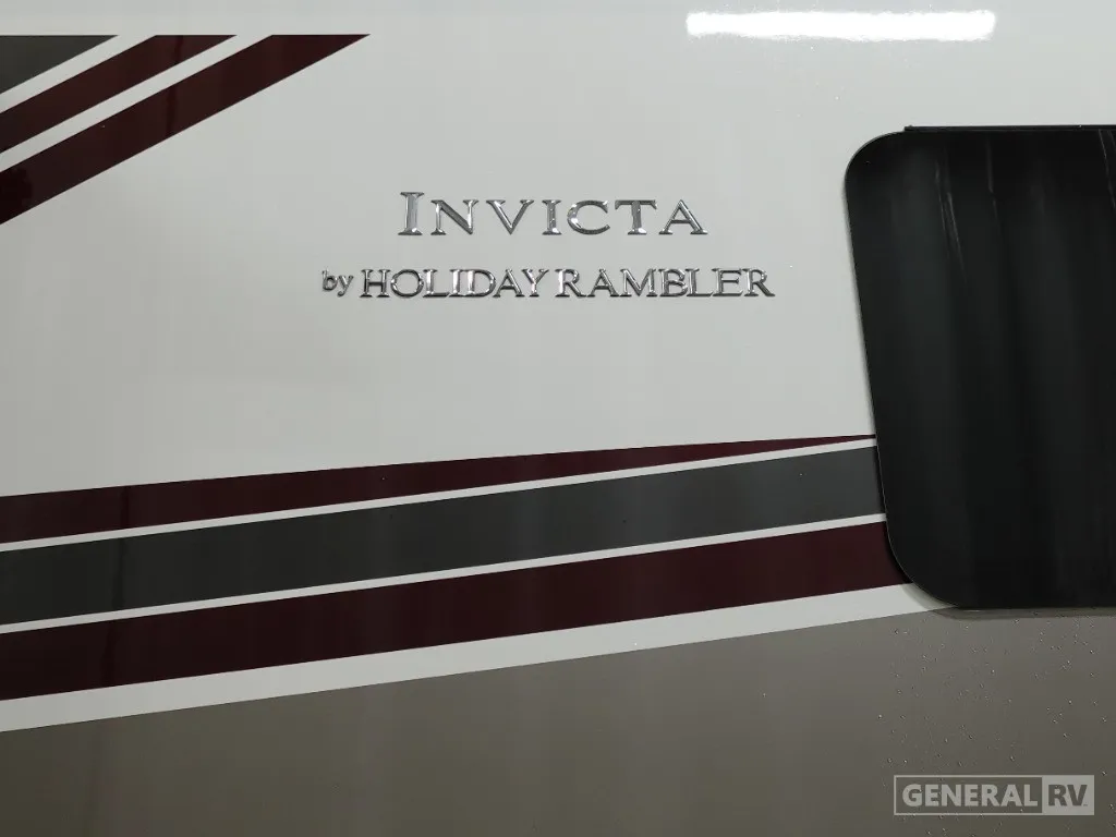 2026 Holiday Rambler Invicta 36Y — Close photograph of the RV's exterior body, graphics, and Invicta badge
