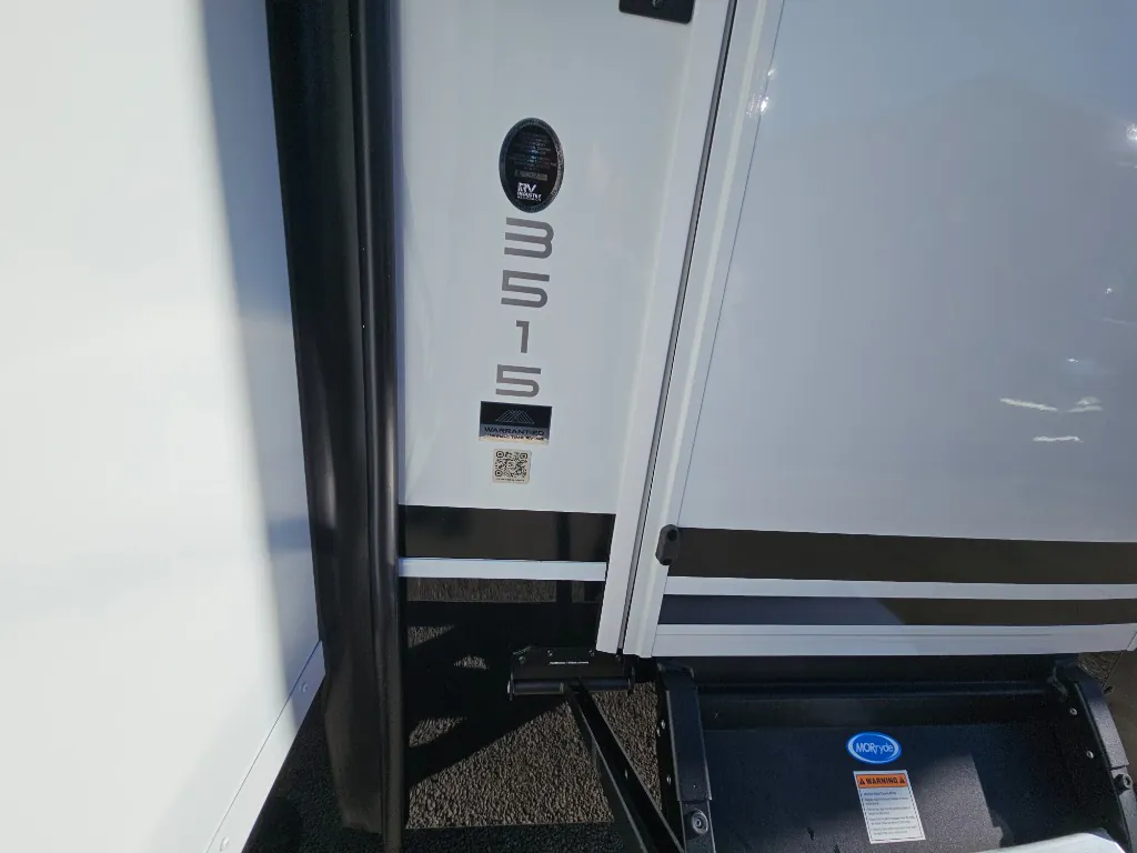 2026 Brinkley Model Z 3515 — Shows the exterior entry area with manufacturer/warranty decals and step assembly