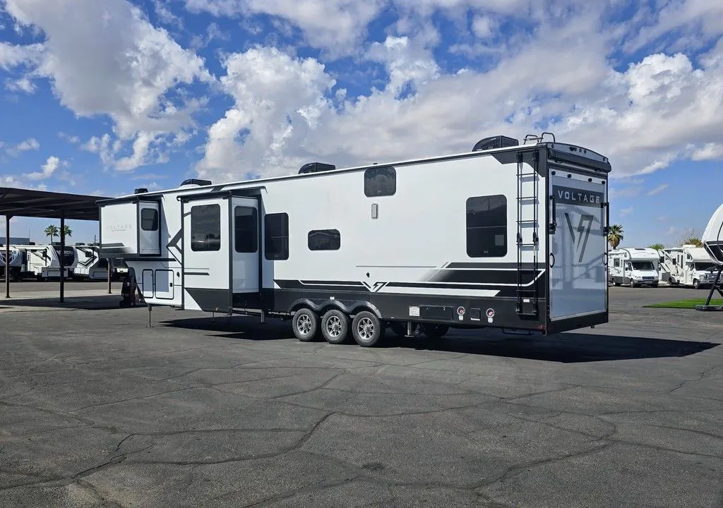 2025 Dutchmen Voltage 4225 — Rear three-quarter exterior photograph visibly shows the RV body, rear ramp/door, wheels, and exterior fixtures